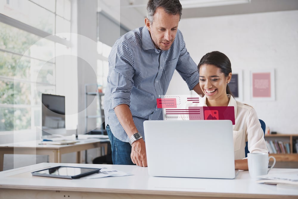 Two smiling colleagues in front of a laptop in a modern office. Digital elements float in front of the screen.